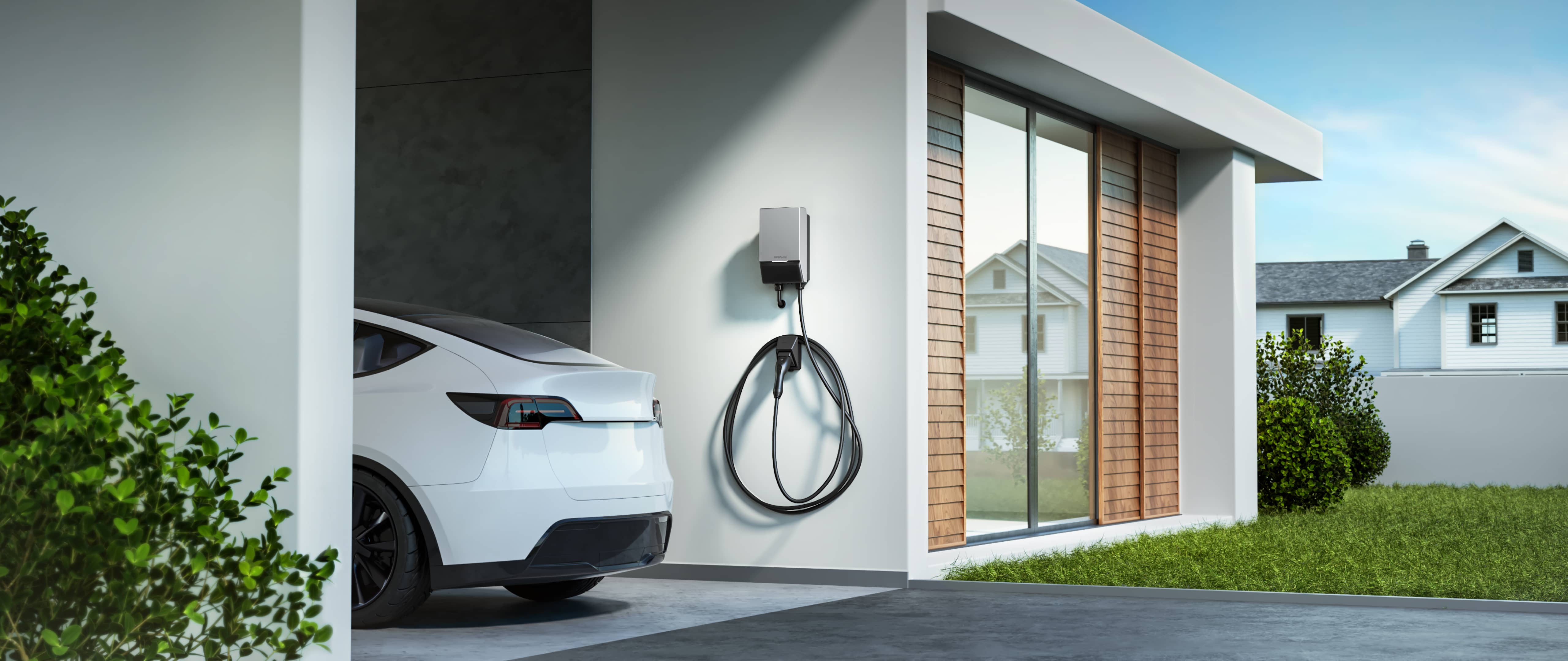 Eine Elektroauto Wallbox und ein Auto an einem Haus